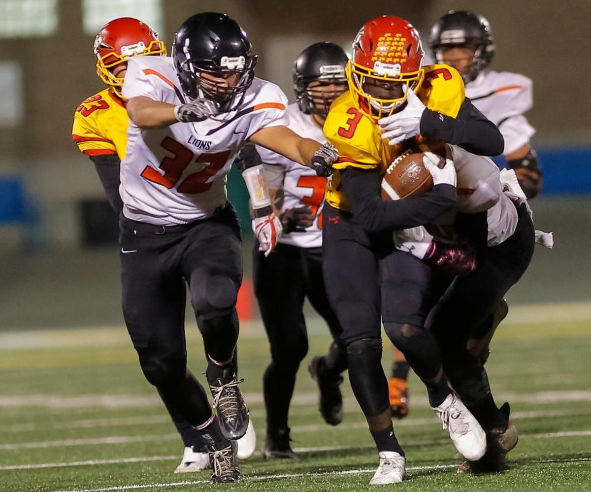 Kennewick's Isaiah Thornton (32) tries to bring down Kamiakin’s Tuna Altahir (3) as the Braves running back carries the ball during Friday’s Mid-Columbia Conference football game at Lampson Stadium. The city rival played a tough first half, with Kamiakin leading 14-6 at the break.