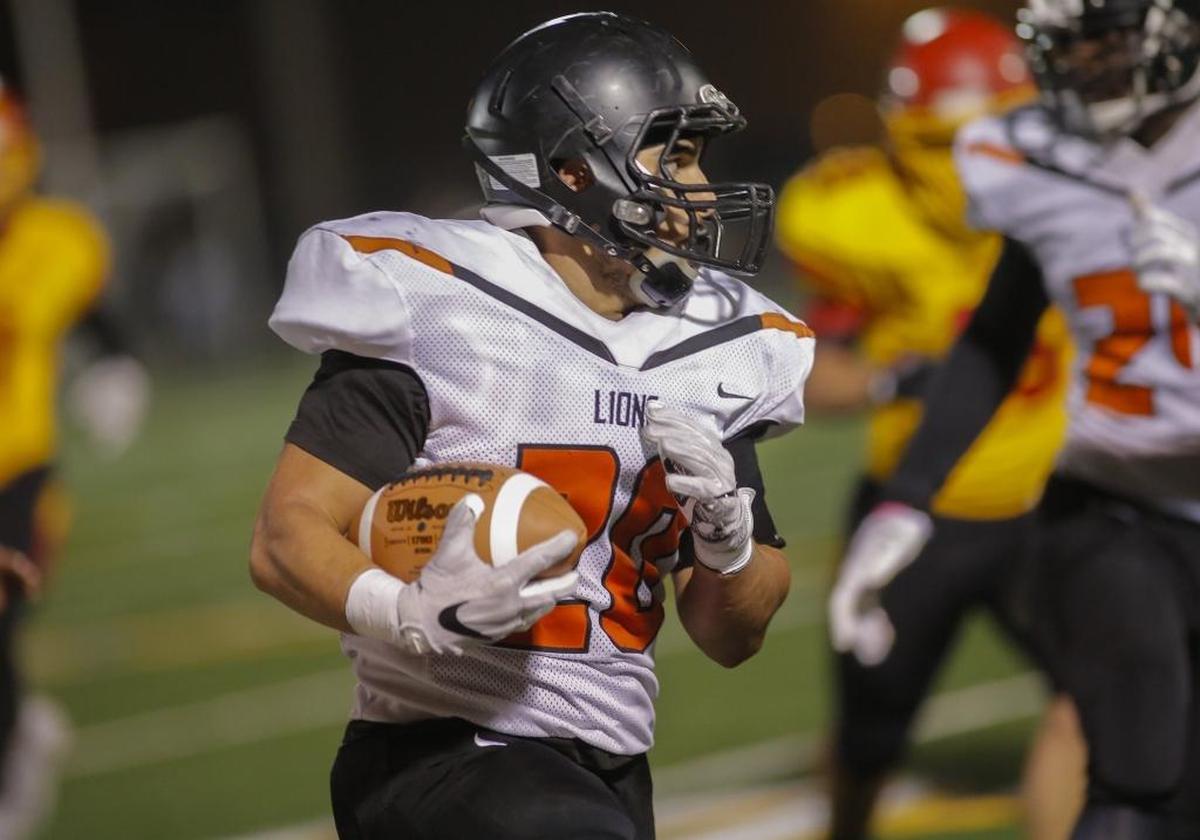 Kennewick's running back Isaac Ruiz (20) runs with the ball during a Mid-Columbia Conference football game against Kamiakin on Friday at Lampson Stadium.