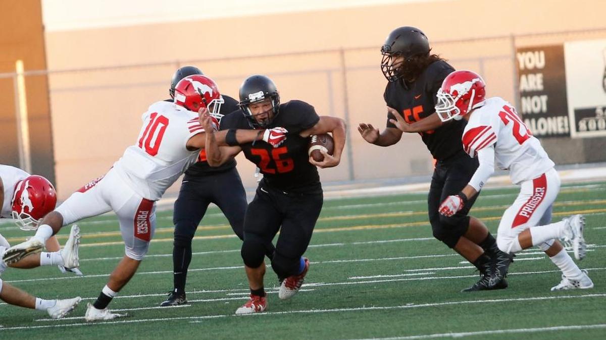 Prosser's Hector Flores (10) attempts to tackle Kennewick's running back JJ Rodriguez (26) during the season-opening game Sept. 1 at Lampson Stadium. Prosser defeated Kennewick 22-14.