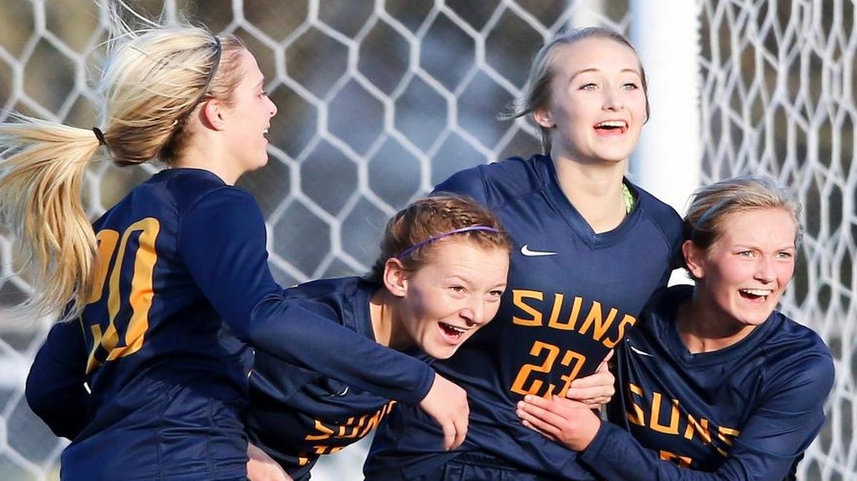 Southridge’s Emma Schutt, (L-R) Syd Sanders, Kendall Pope and Kelly Brown celebrate the Suns’ 1-0 win over Arlington in the Class 3A state semifinals Friday afternoon at Sparks Stadium in Puyallup.