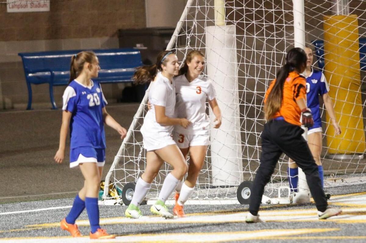 Kamiakin's Izzy Conover (14) and River Holle (3) celebrate after Conover scores a goal against Walla Walla on Sept. 21 at Lampson Stadium. Conover is third in the league in scoring with 13 goals, and the Braves are 10-0 heading into Tuesday’s game against Chiawana