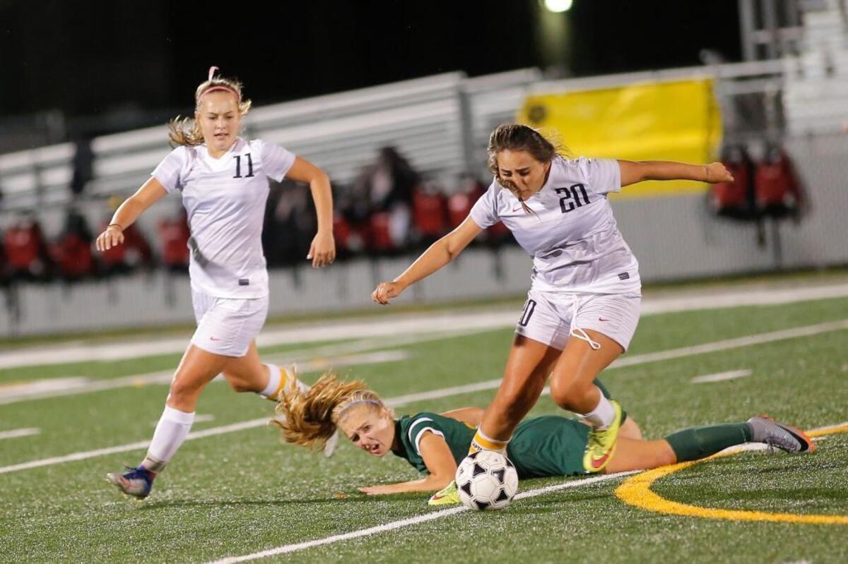 Kamiakin seniors Kaylee Kraft (11) and Kahlea Sullivan (20) team up to take the ball from Richland’s Gabrielle Fillmore during a Mid-Columbia Conference girls soccer game at Lampson Stadium in Kennewick on Thursday. The Braves defense pitched its seventh shutout of the season to get a 1-0 win and improve their record to a perfect 12-0.