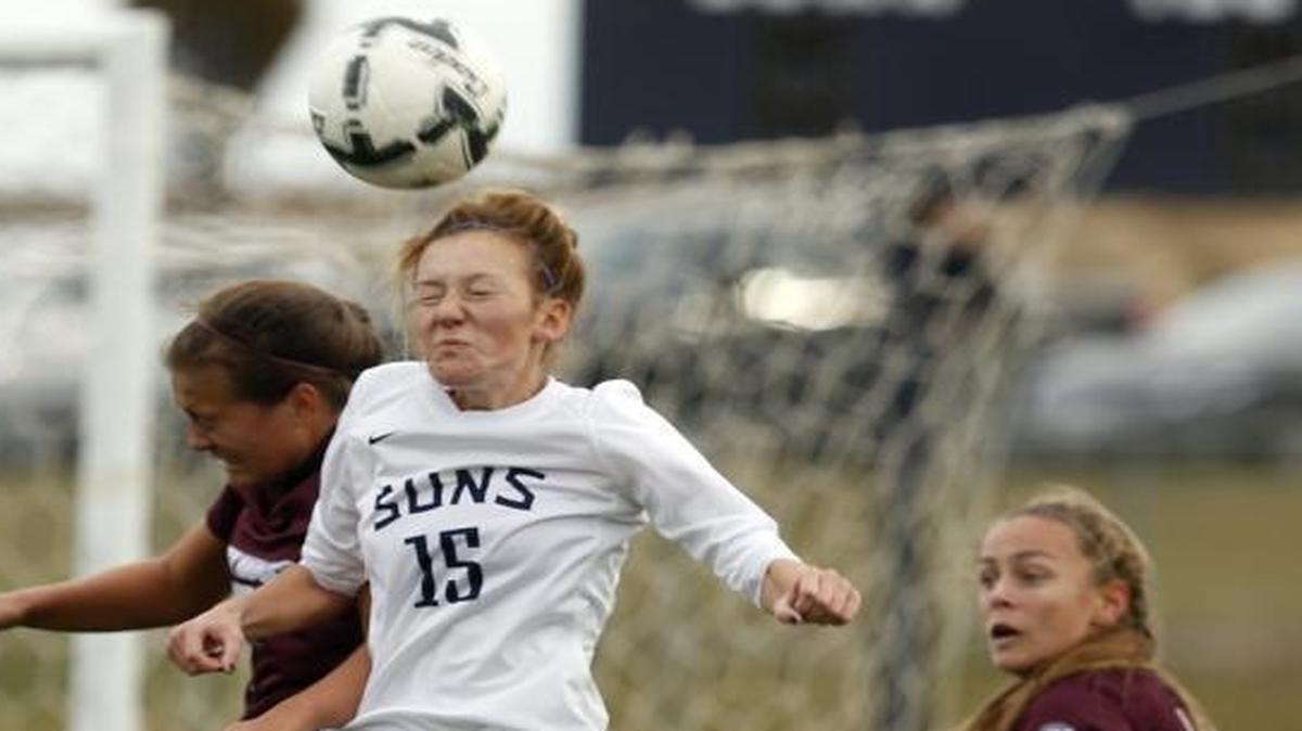 Southridge’s Syd Sanders (15) and Holy Names Academy’s Claire Tevaseu (7) fight to head a ball during Saturday’s Class 3A state playoff game at Southridge High School.