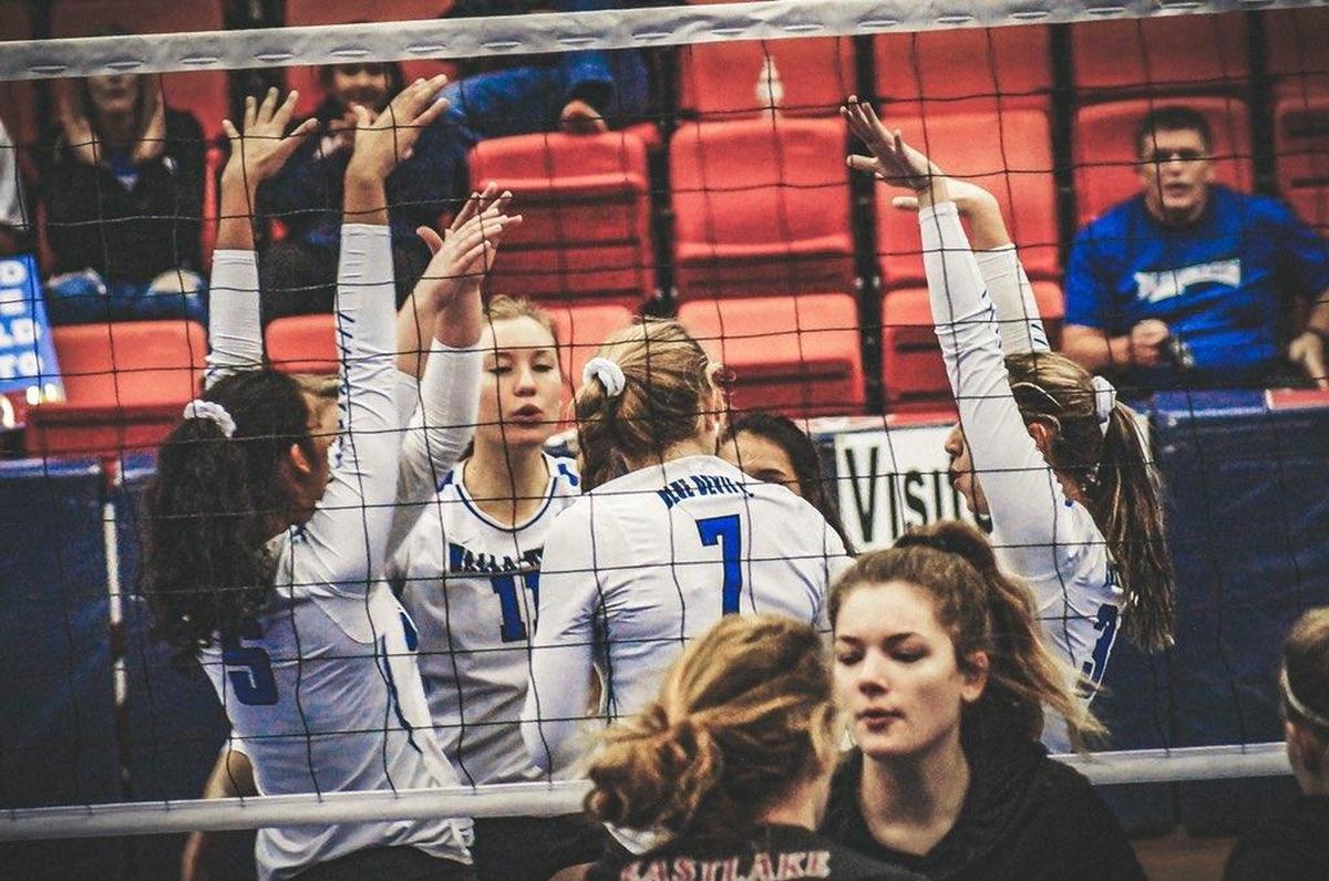 The Walla Walla volleyball team celebrates a block by Hannah Hair (7) during their match Saturday against Eastlake at the 3A state tournament at Toyota Center.