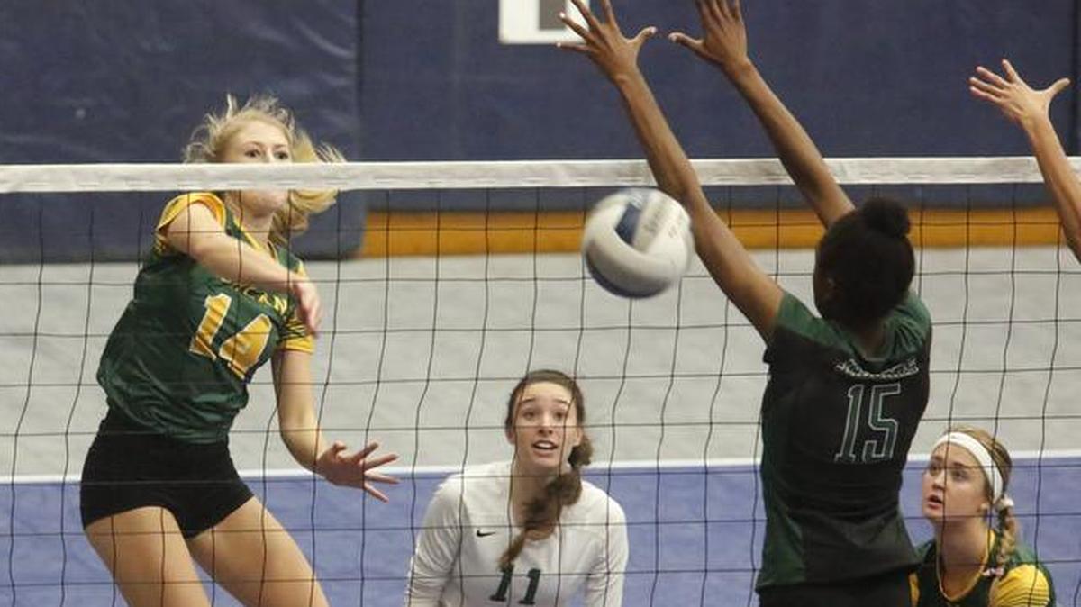 Richland’s Hailey Daves hits past Emerald Ridge’s Kava Durr in the first-round of the 4A state volleyball championships at the Toyota Center in Kennewick. The Bombers were eliminated after losing both of their matches.