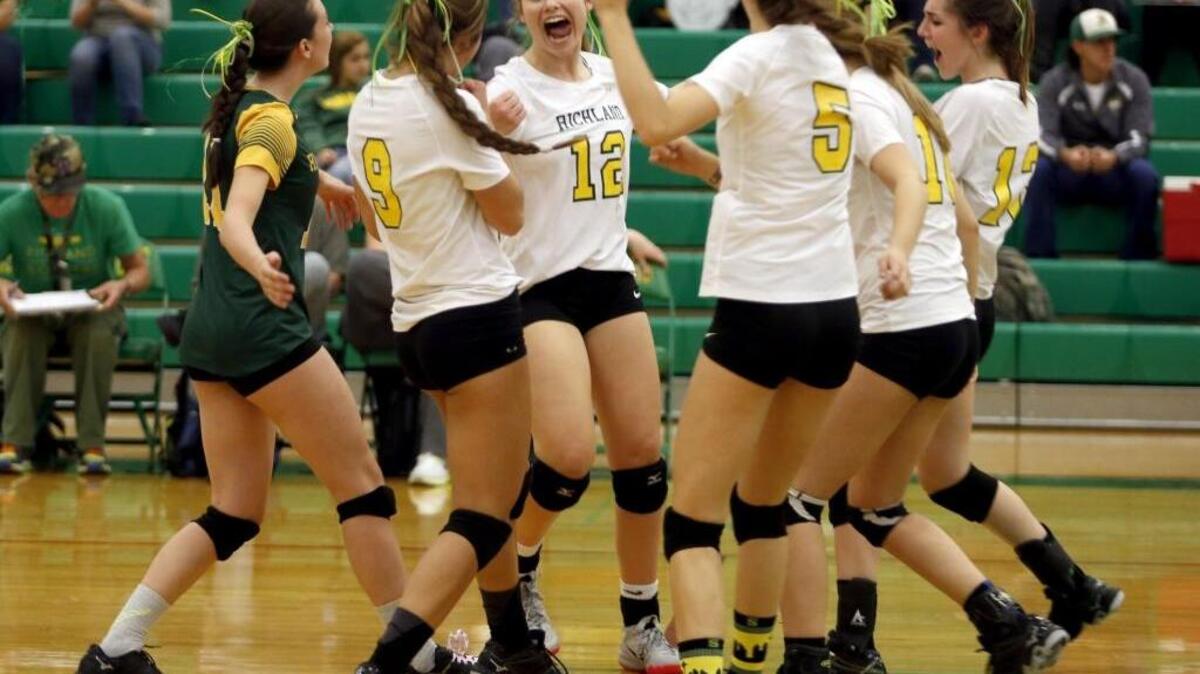 Richland celebrates a point Saturday during the district title game against Chiawana at Art Dawald Gymnasium. Richland won the match in three games.