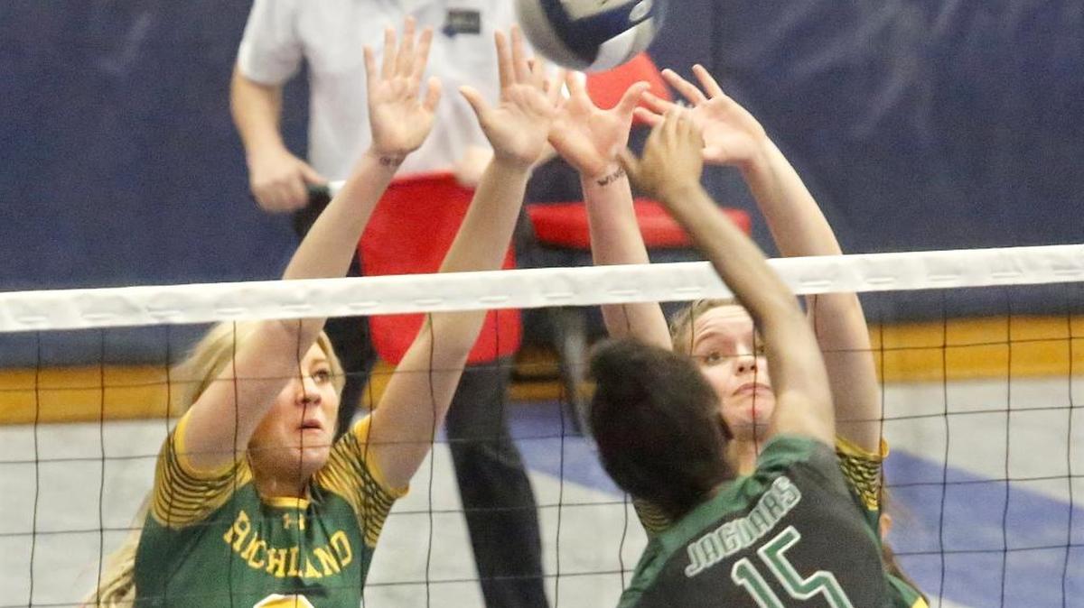 Richland's Brie Harrison (3) and Lindsay Rothenthal team up to try blocking a shot by Emerald Ridge's Kava Durr during Friday's first-round 4A state volleyball match at the Toyota Center in Kennewick. The Bombers lost the match in five sets.