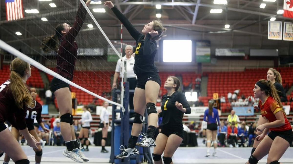 Kamiakin’s Carlee Rowell (2) tries to hit the ball past Mercer Island’s Helena Shield (4) during the first round of the Class 3A state volleyball tournament Friday at Toyota Center in Kennewick. Kamiakin lost in four games.