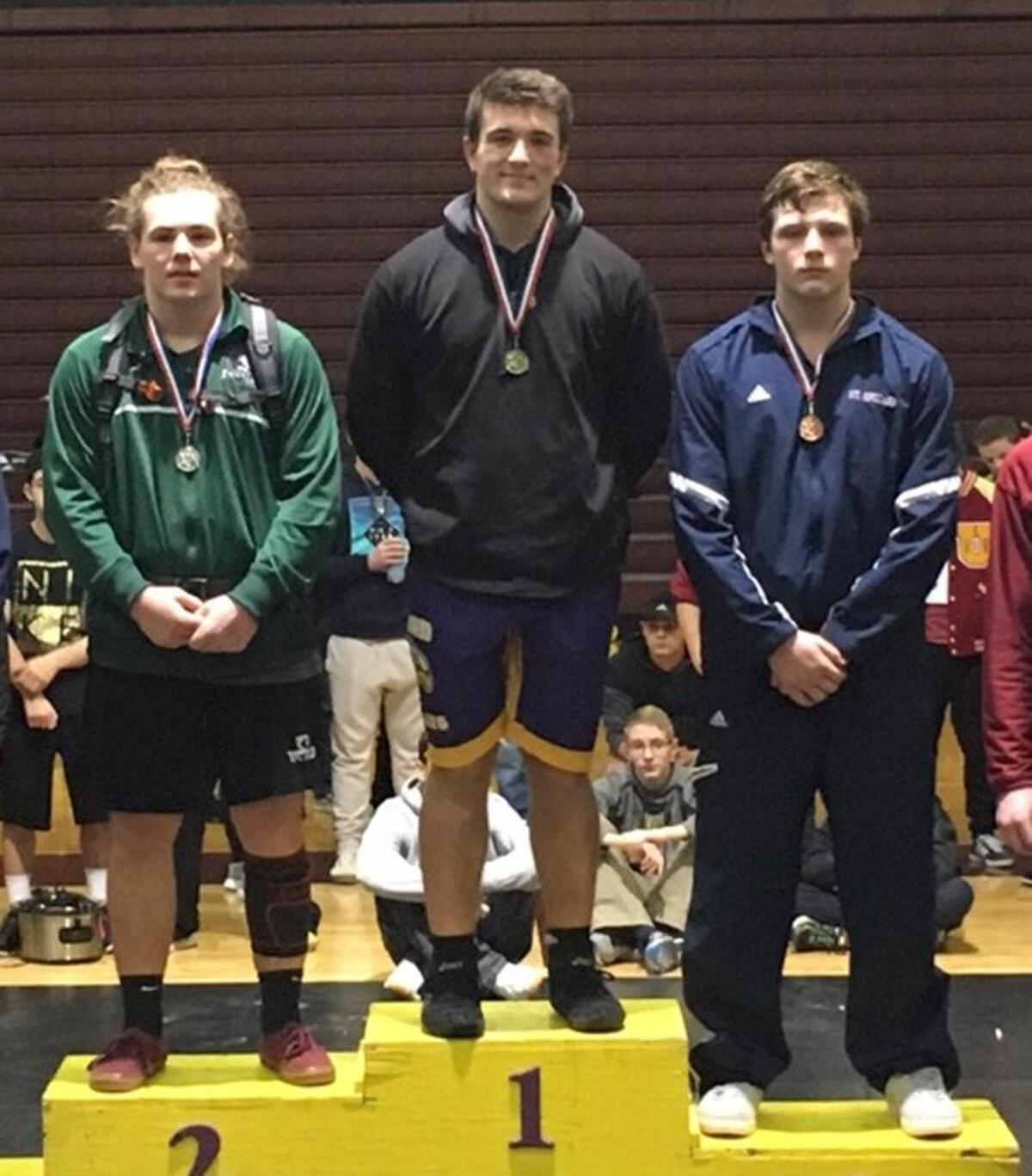 Hanford’s Jonathan Burt (center) won the 220-pound title Saturday at the Pacific Northwest Classic at University High School in Spokane.