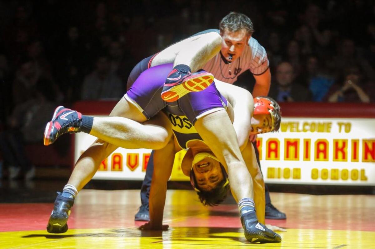 Pasco’s Avery Burrows, bottom, wrestles in a 182-pound match against Kamiakin’s Jacob Olson on Thursday at Kamiakin High School. Burrows won 7-4.