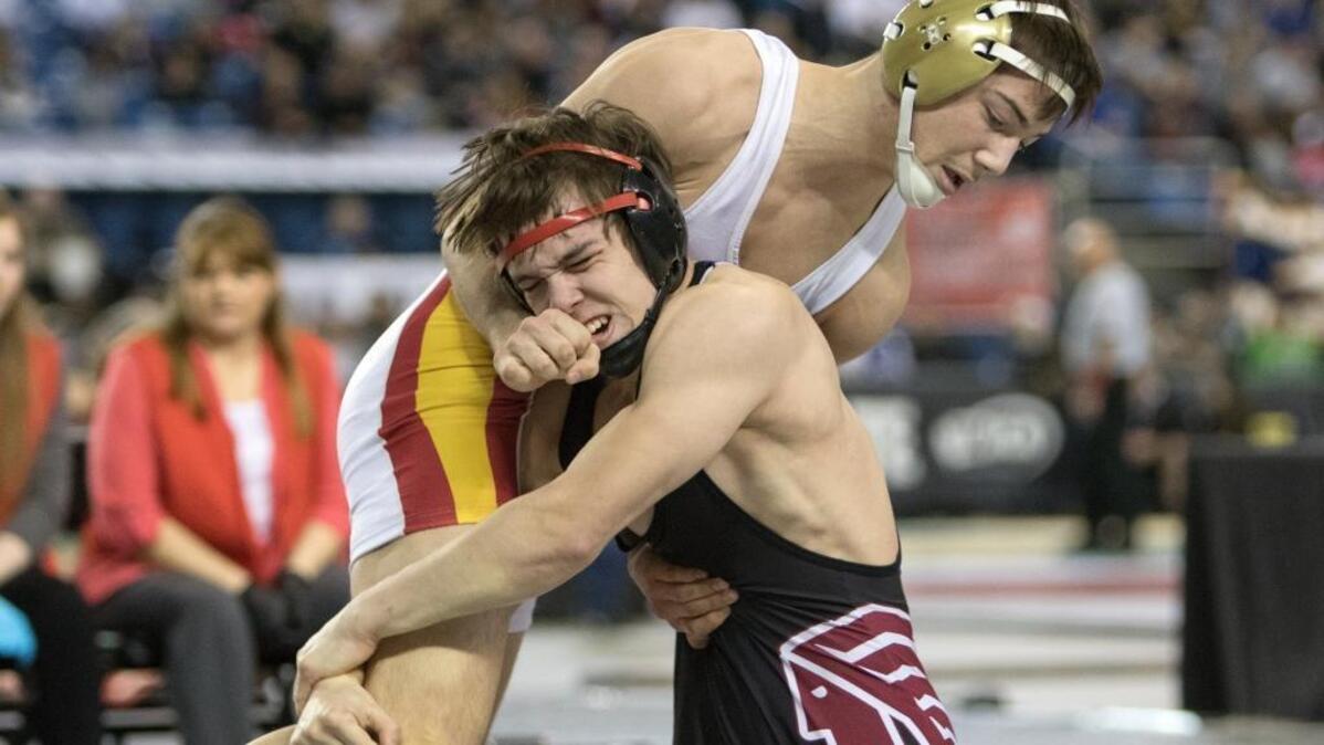 Kamiakin’s Austin Almaguer, top, stuffs the takedown attempt by North Central’s Clayton Gilliam during their 132-pound championship match at the 3A state wrestling tournament Saturday at the Tacoma Dome. Almaguer won the match 6-1.