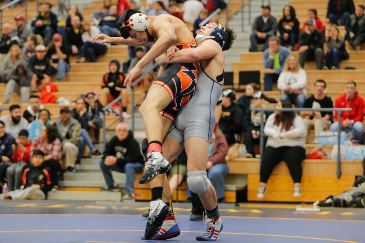 Southridge’s Mikael Failor lifts Kennewick’s Emilio Ramos during their 160-pound championship match Saturday at the Mid-Columbia Conference 3A District Championships at Southridge. Ramos won 2-1.