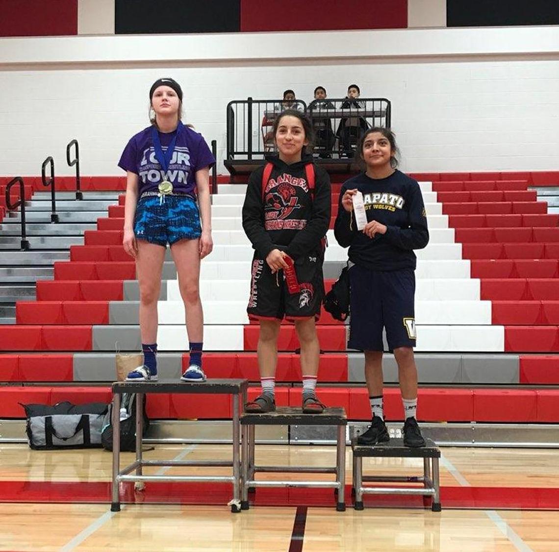 Hanford’s Taylor Wilson, left, won the 100-pound title Saturday at the South Girls Sub-Regional tournament in Granger.