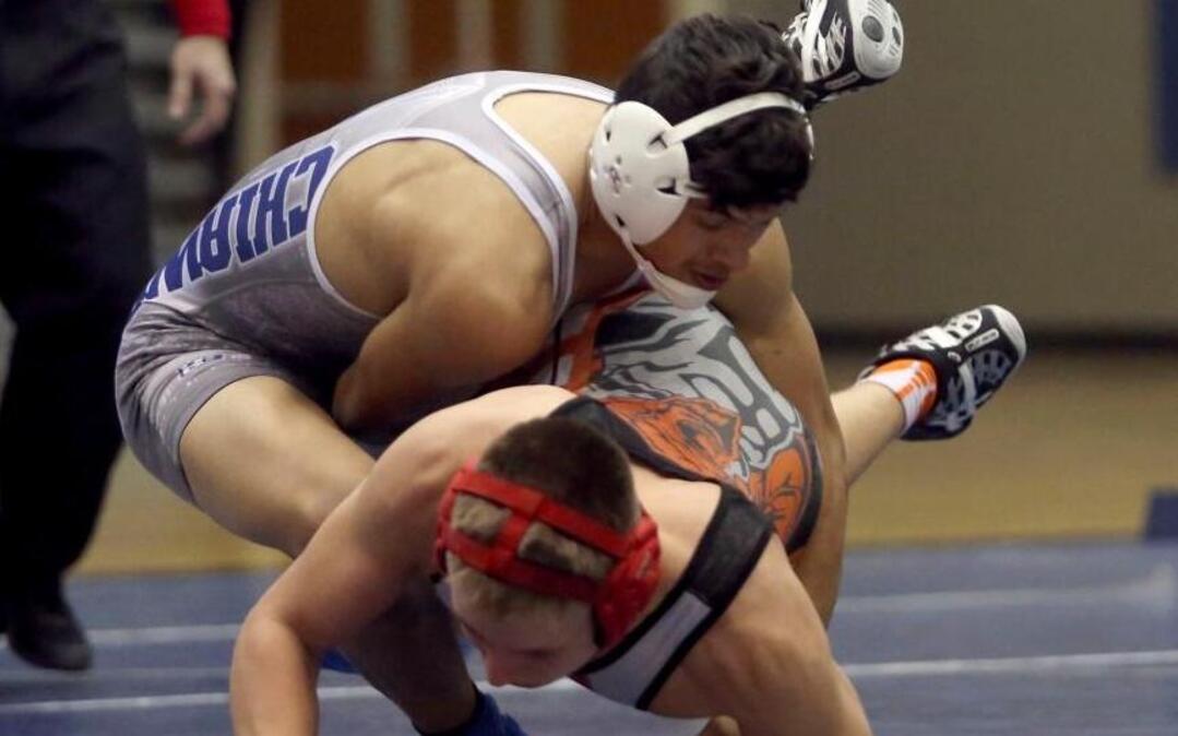 Chiawana High School’s Jonathan Miranda takes down Kennewick High School’s Dylan Holt during Tuesday’s 138-pound wrestling match in Pasco. Miranda pinned Holt in 1:05. See more photos at www.tricityherald.com.