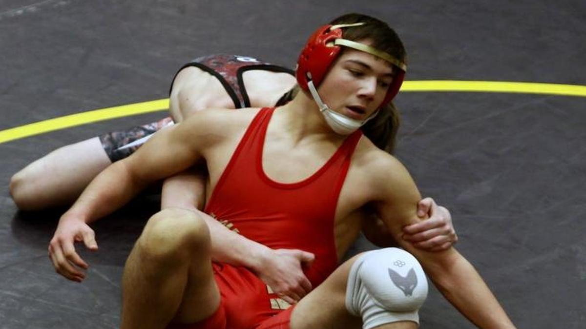 Kamiakin’s Austin Almaguer (in red) wrestles East Valley’s (Yakima) Micah Miller in the quarterfinals of the 120-pound weight class Friday during the Hanford Winter Cup wrestling tournament at Hanford High School. See more photos at www.tricityherald.com.