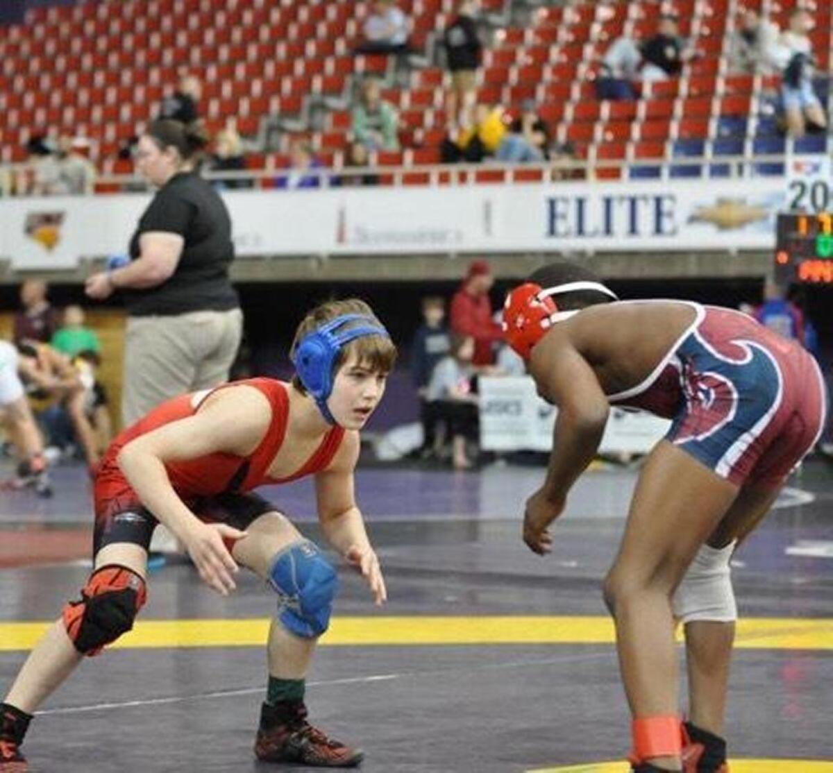 Jacob Olson (left) competes in the intermediate division at the national championships in Utah at 9 years old. He won a national title in his weight class.