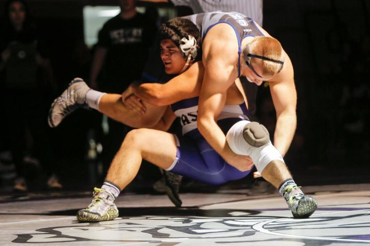 Pasco’s Anthony Cortez lifts Chiawana’s Ian Campbell while wrestling in a 220-pound bout during a Mid-Columbia Conference dual on Saturday at Pasco High School. Chiawana won 33-25.