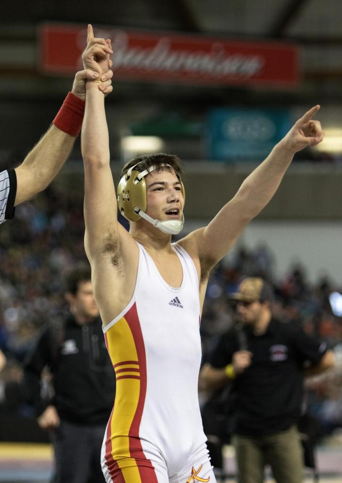 Kamiakin’s Austin Almaguer salutes the crowd after defeating North Central’s Clayton Gilliam during their 132-pound championship match at the 3A state wrestling tournament Saturday at the Tacoma Dome. Almaguer won the match 6-1.
