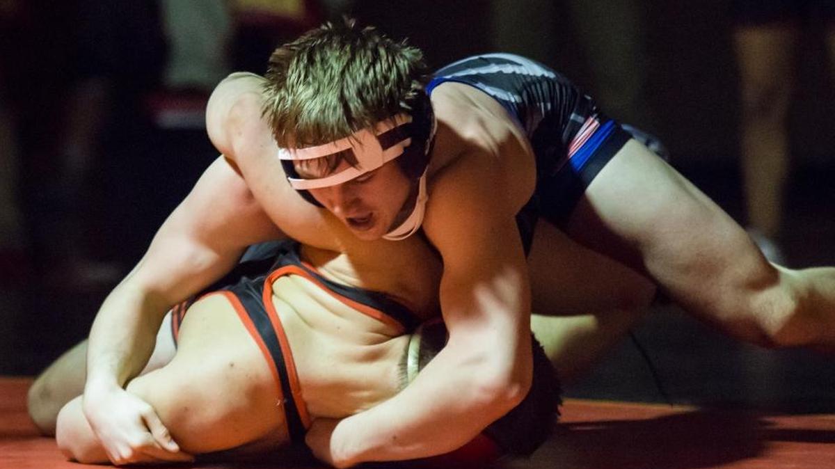 Chiawana’s Tyson Stover (top) tries to control Kamiakin’s Jacob Olson during their 182-pound match Wednesday. Stover won 6-5.