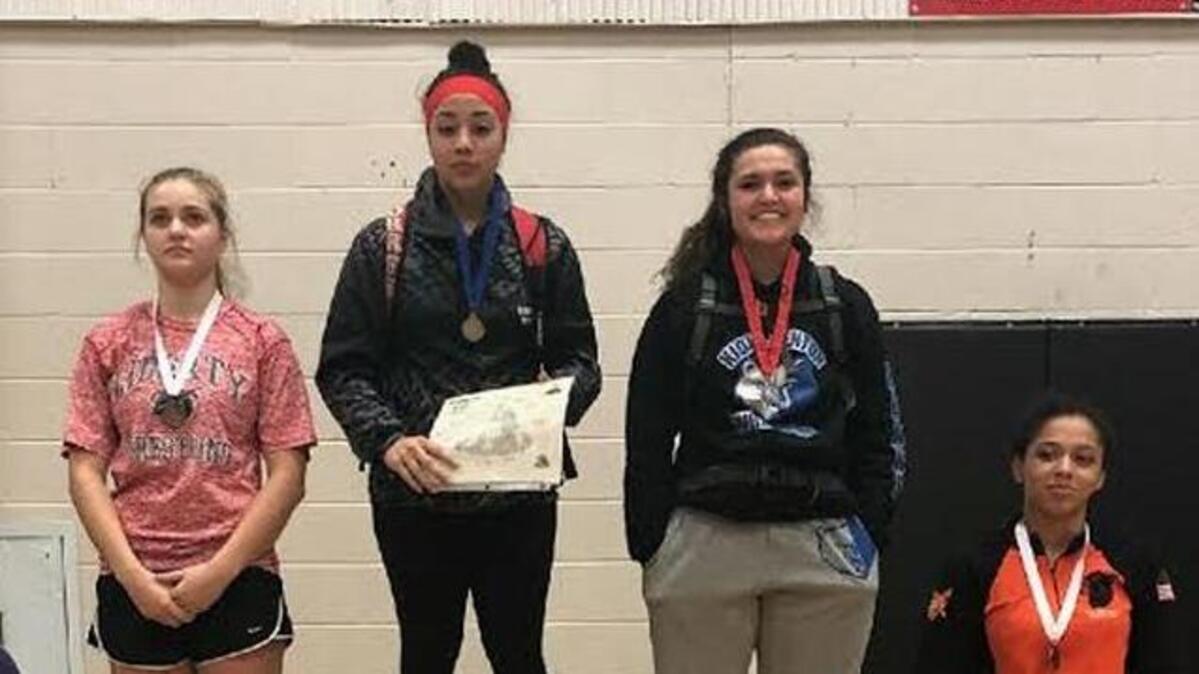 Kiona-Benton’s Maloree Calzadillas (second from right), in her first year of wrestling, finished second at regionals and earned a trip to state.
