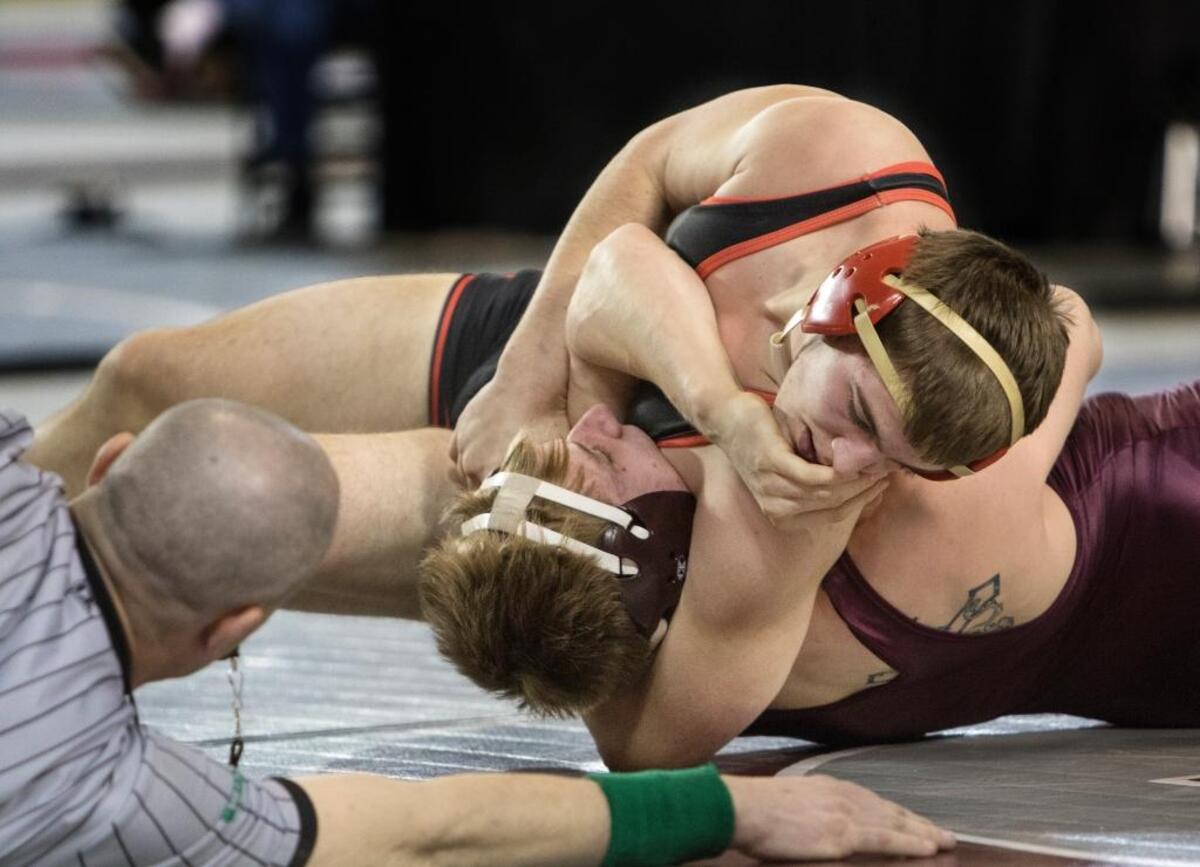 Kamiakin’s Jacob Olson, top, puts the squeeze on O’Dea’s Alan Badley during their 170-pound championship match at the 3A state wrestling tournament Saturday at the Tacoma Dome. Olson won by pin in 39 seconds.