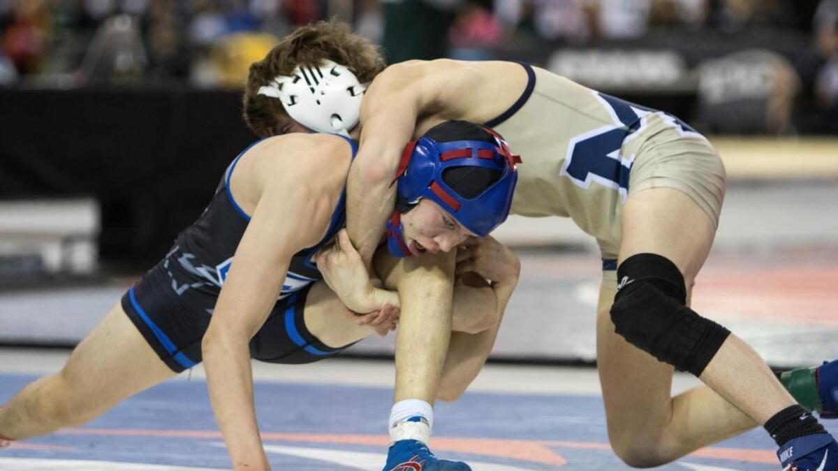 Chiawana’s Robby Vaughn, left, looks to break free from the grasp of Mead’s Chase Tebbets during their 120-pound championship match at the 4A state wrestling tournament Saturday at the Tacoma Dome. Vaughn lost 5-3 to take second place.