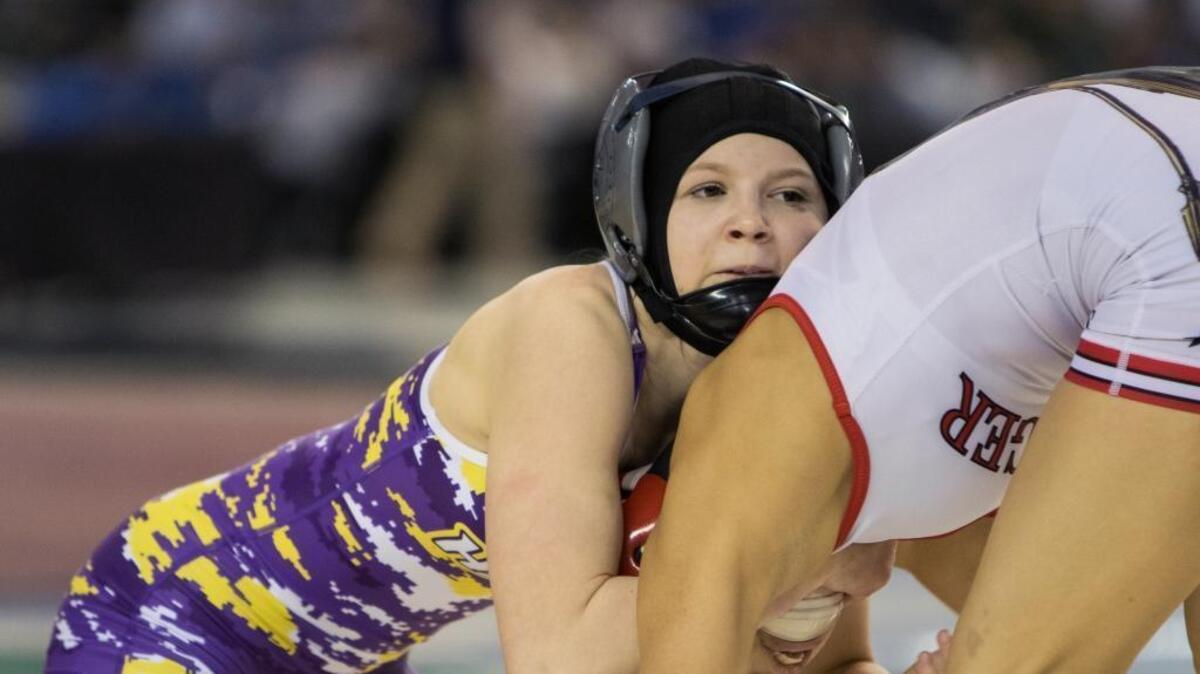 Hanford’s Taylor Wilson, left, controls Granger’s Nizhoni Tallman during their 100-pound championship match at the state wrestling tournament Saturday at the Tacoma Dome. Wilson won the title by disqualification. She was bitten by Tallman during the match.