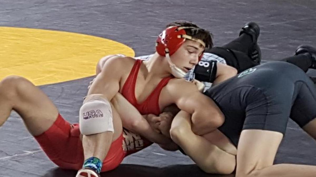 Kamiakin’s Austin Almaguer, left, has Riley Wynn of Peninsula tied up in their 120-pound first-round match at Mat Classic in Tacoma. Almaguer advanced with a 16-0 win but lost in the quarterfinals.