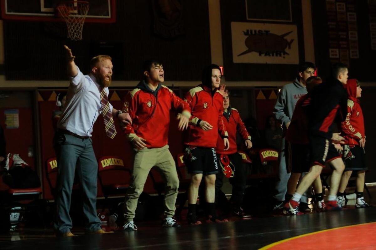 Kamiakin wrestling coach Jordan Anderson and his team encourage a wrestler during their match Thursday against Pasco at Kamiakin High School. Pasco won by criteria 37-36.
