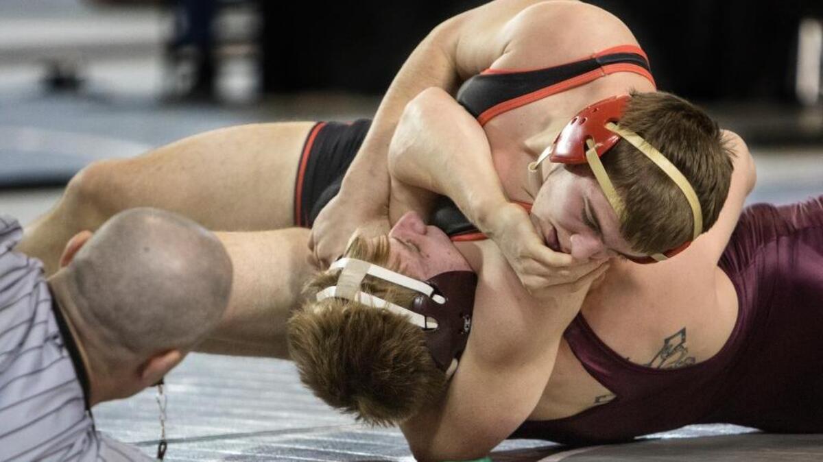 Kamiakin’s Jacob Olson, top, puts the squeeze on O’Dea’s Alan Badley during their 170-pound championship match at the 3A state wrestling tournament Saturday at the Tacoma Dome. Olson, who won by pin, was named to the Mid-Columbia Conference’s first team at 170 pounds.
