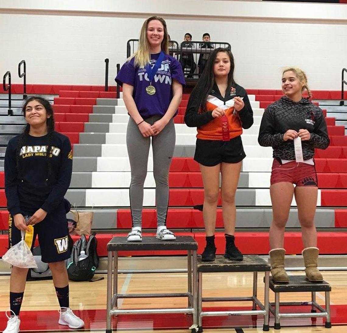Hanford’s Taylor Robinson (second from left) won the 120-pound title Saturday at the South Girls Sub-Regional tournament in Granger.