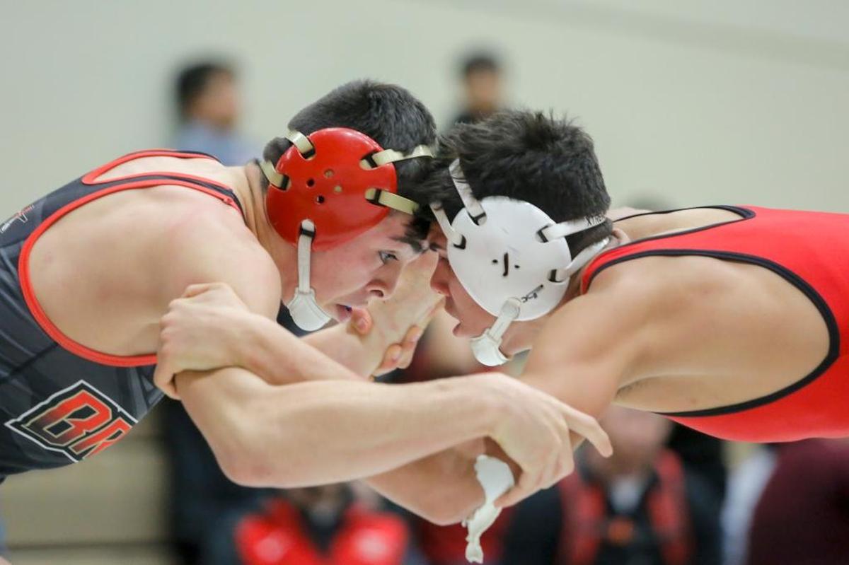Kamiakin’s Joey Chavez, left, wrestles with Granger’s Juan Isiordia in the 145-pound title match Saturday during the Hanford Winter Cup. Isirodia won 2-0.
