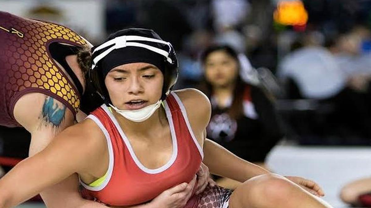Othello’s Nikki Velazquez, right, works to get an escape point against White River’s Erin Redford during their 130-pound state championship match Feb. 18 in Tacoma. Velazquez lost 13-6 to take second place.