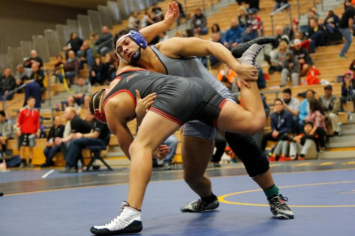 Southridge’s Jevon Johnson takes down Kamiakin’s Gibby Marquez in the 182-pound finals Saturday during the Mid-Columbia Conference 3A District Championships at Southridge. Johnson pinned Marquez in the third round.