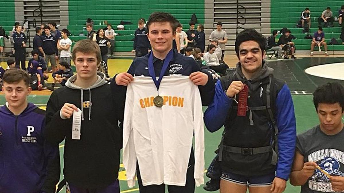 Chiawana’s Riley Cissne (center) won the 142-pound title Saturday at the 4A Mid-Columbia Conference district tournament at Richland High.