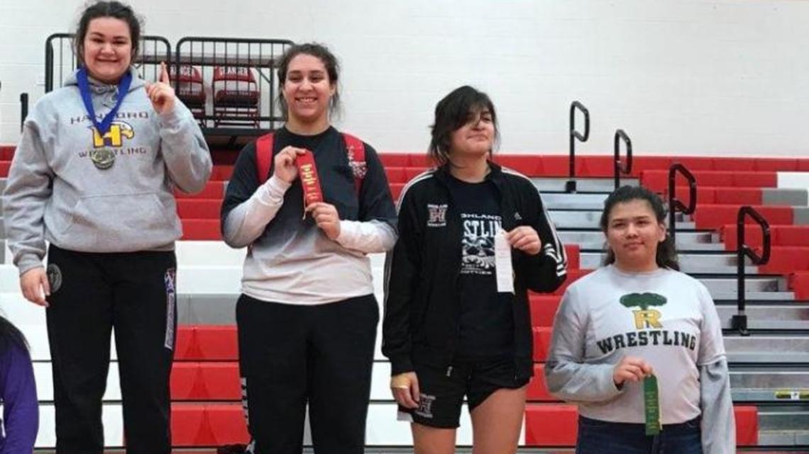 Hanford’s Grace Nelson (third from left) won the 190-pound title at the South Girls Sub-Regional tournament Saturday in Granger.