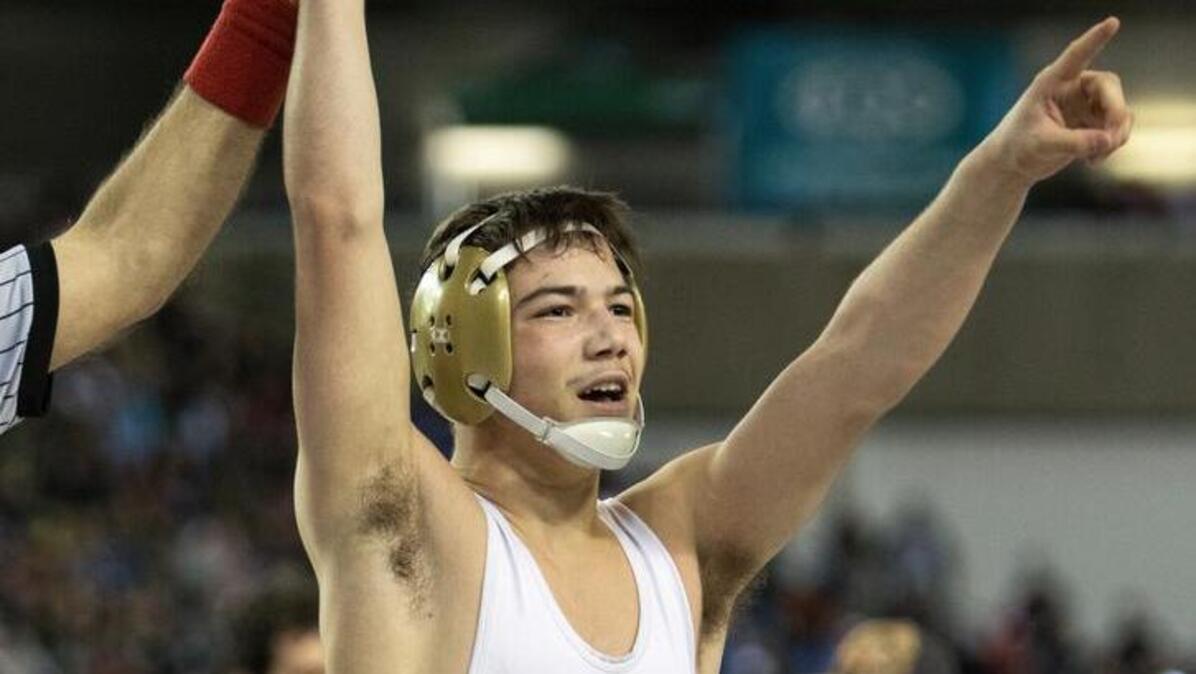 Kamiakin’s Austin Almaguer salutes the crowd after defeating North Central’s Clayton Gilliam during their 132-pound 3A state championship match Feb. 17 at the Tacoma Dome. Almaguer won the match 6-1.