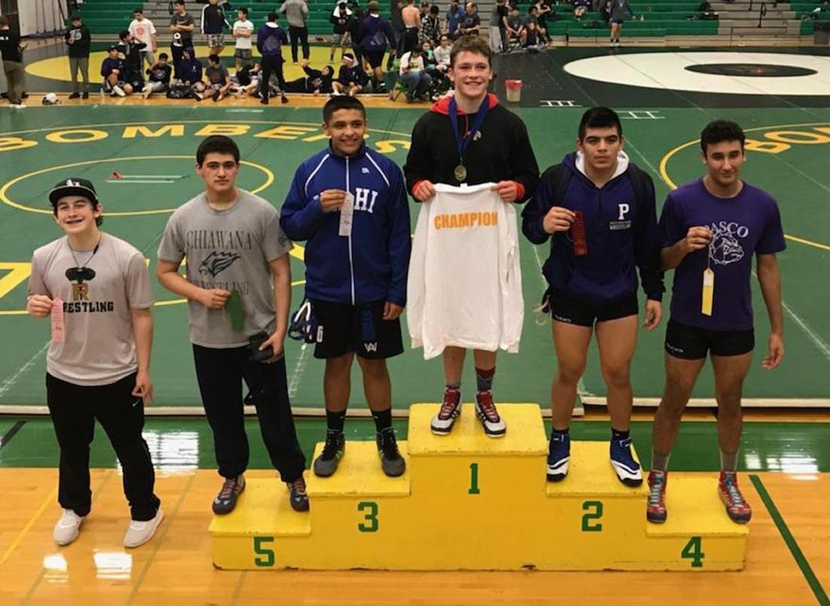 Hanford’s hayden Henry (center) won the 182-pound title Saturday at the 4A Mid-Columbia Conference district tournament at Richland High.