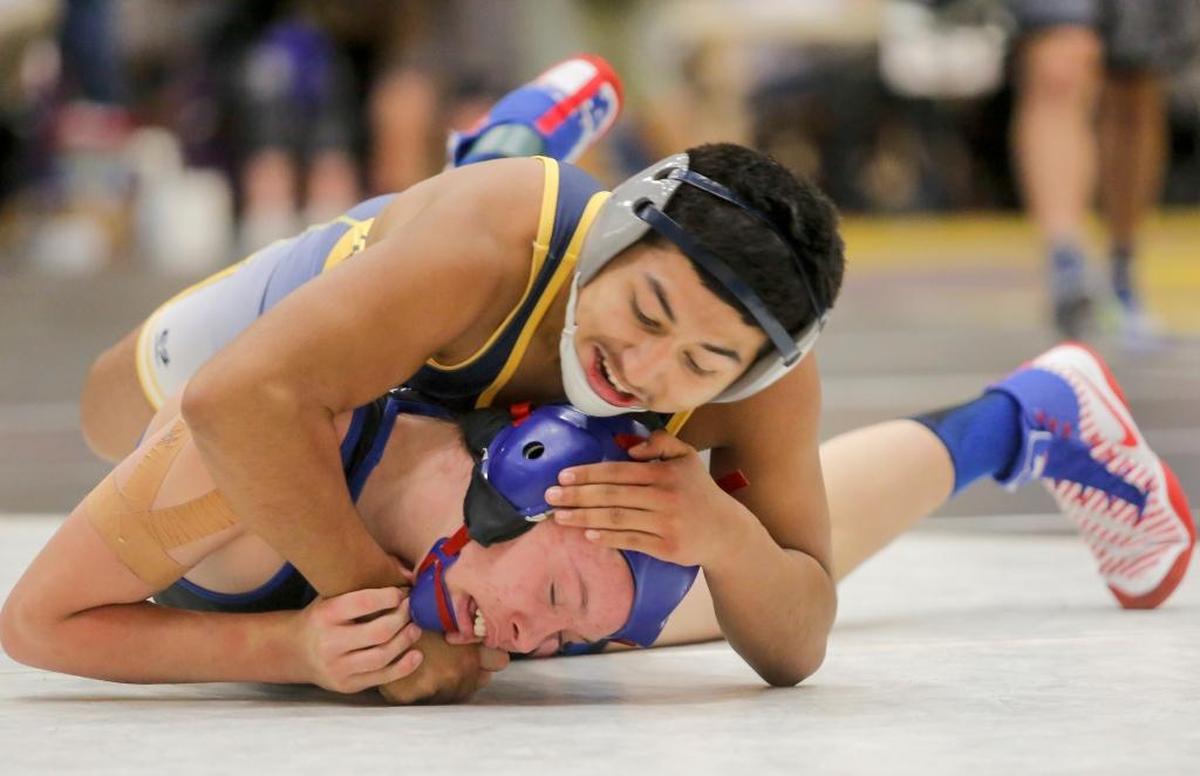 Wapato’s Jesus Rodriguez Jr., top, wrestles with Chiawana’s Robby Vaughn in the 126-pound championship match Saturday at the Hanford Winter Cup. Vaughn won 1-0.