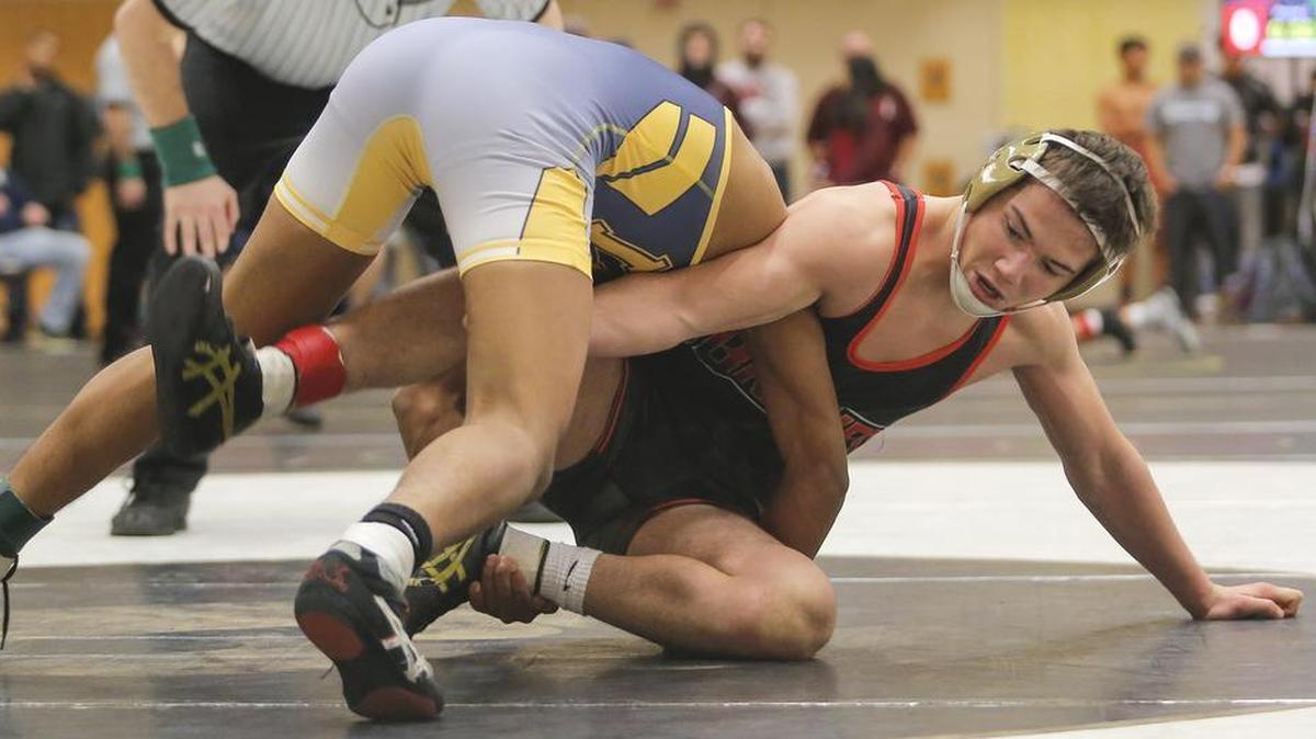 Kamiakin’s Austin Almaguer, right, wrestles Wapato’s Sergy Salas in the 132-pound title match Saturday at the Hanford Winter Cup. Salas won 3-2.