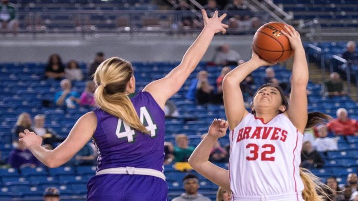 Kamiakin’s Jayden Williams (32) lets a jump shot fly over Missy Peterson of Edmonds-Woodway on Thursday in a Class 3A state tournament quarterfinal in Tacoma.