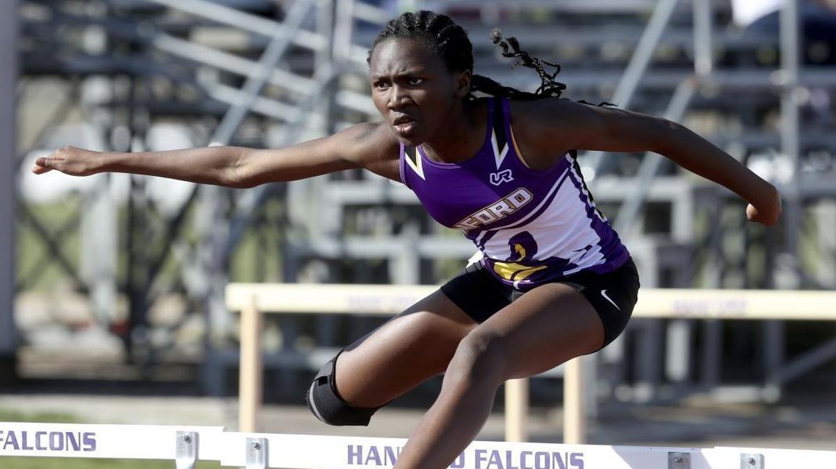 Hanford High School’s Nyenuchi Okemgbo gets air Thursday in the girls 100-meter hurdles during a track meet at Hanford High School in Richland. Okemgbo’s win in the event helped the Falcons beat Richland and Chiawana.