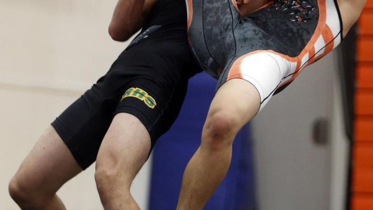 Kennewick’s Alex Ramos wrestles Richland’s Anthony Lovato in the 152-pound weight class Thursday during a Mid-Columbia Conference match at Kennewick High School. See more photos at www.tricityherald.com.