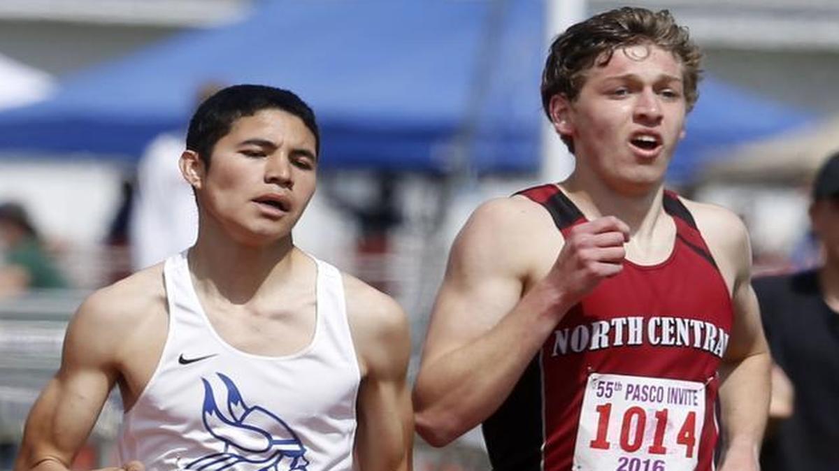 Umatilla High School’s Fabian Cardenas races past North Central’s Justin Janke to finish third in the boys elite mile during the 55th annual Pasco Track and Field Invitational last month at Edgar Brown Memorial Stadium.