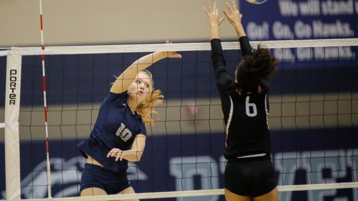 Chiawana’s Kylie Thorne attempts to spike the ball past the block of Kennewick’s M'Kaylah Mangum during an MCC volleyball match Thursday at Chiawana High School. The Riverhawks won the match 3-1.