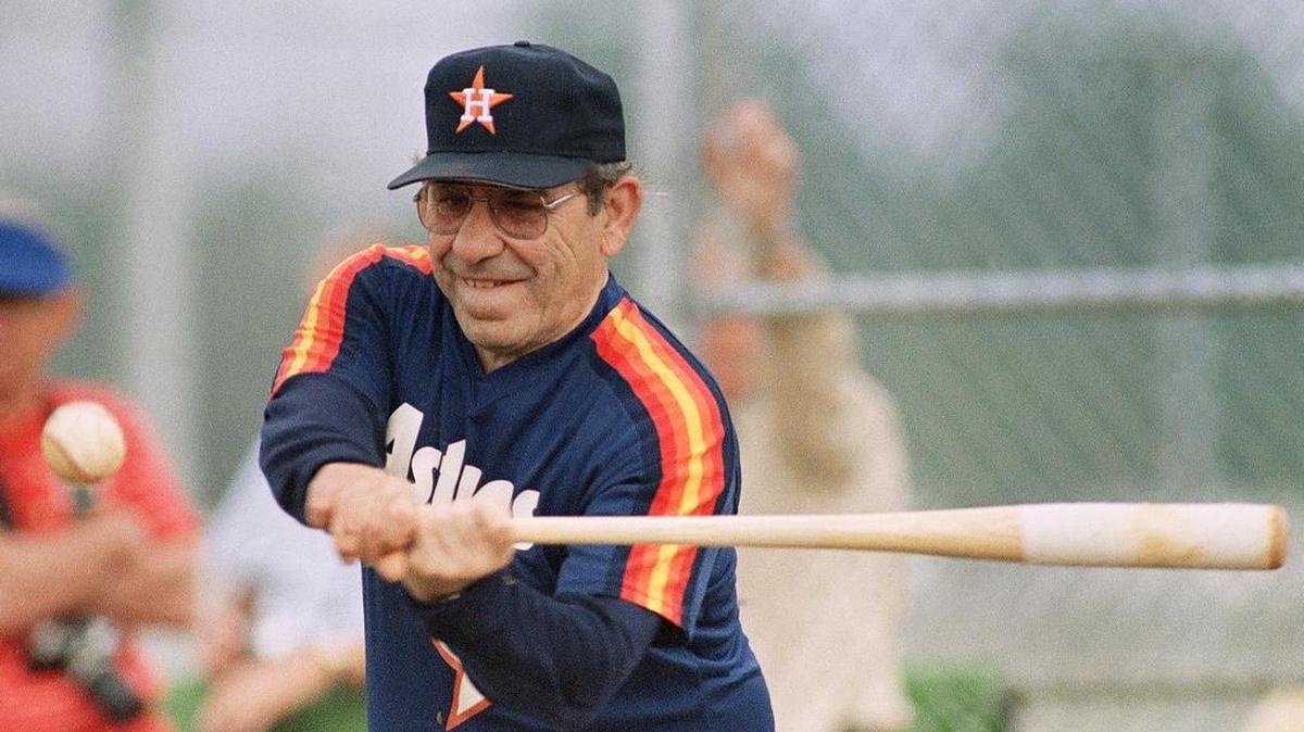 
Hall of Fame member Yogi Berra now a coach with the Houston Astros, hits a fungo to the Astros infield at training camp in Kissimmee, Fla., on Wednesday, Feb. 25, 1987. 
