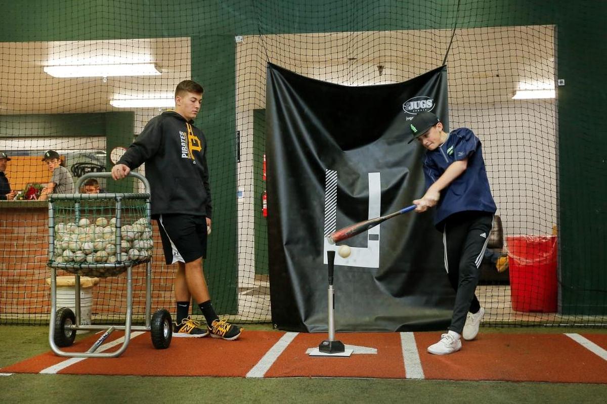 Mason Martin, left, a former Southridge baseball player, works with Carson French at The Batters Box in Kennewick. Martin was drafted by the Pittsburgh Pirates in the 17th round of June’s MLB Draft.