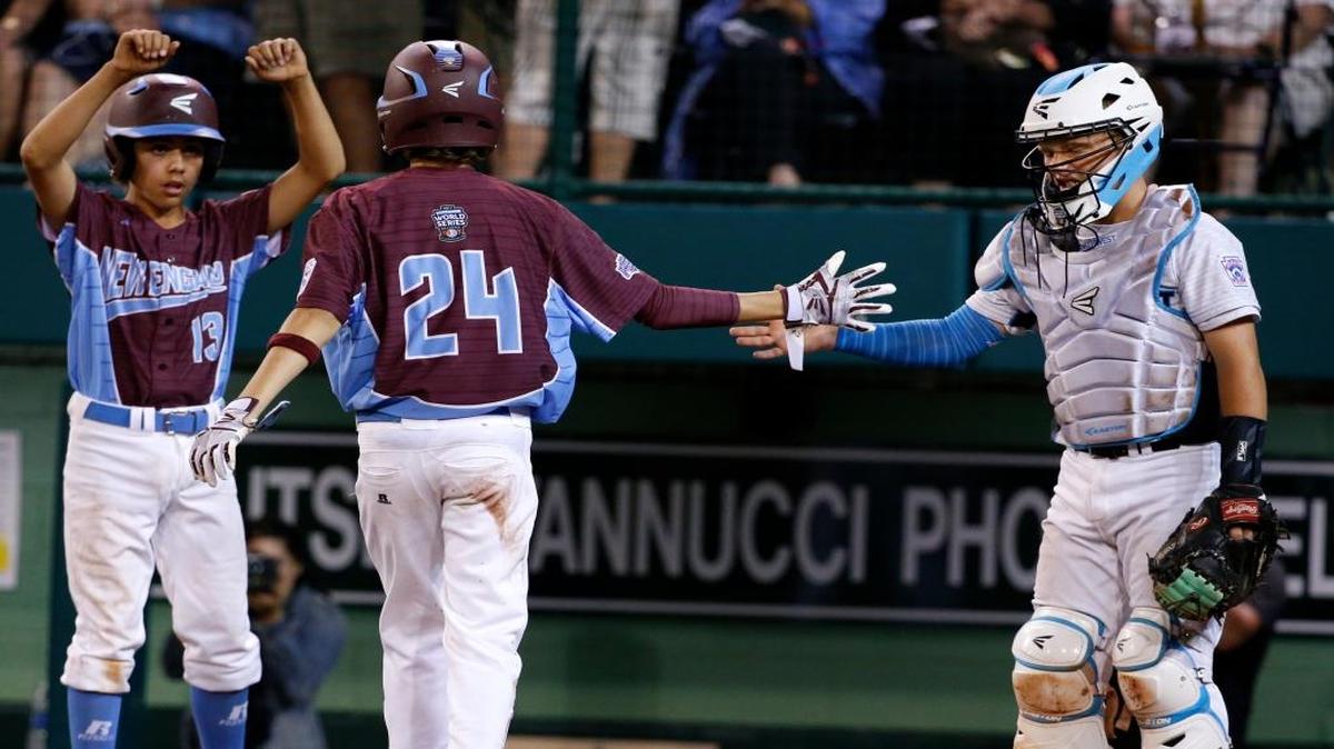 Fairfield, Conn.'s Michael Iannazzo (24) crosses home plate to congratulations from Walla Walla catcher Keegan Weston, right, and teammate Ethan Righter (13) after hitting a two-run home run in the fifth inning of an elimination game in at the Little League World Series in South Williamsport, Pa., Monday, Aug. 21, 2017. Connecticut won 14-6.