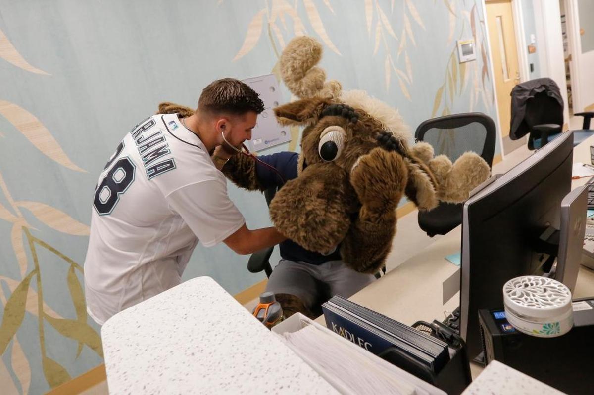 Seattle Mariners catcher Mike Marjama checks Mariner Moose’s heartbeat during a previous visit to Kadlec Regional Medical Center in Richland.