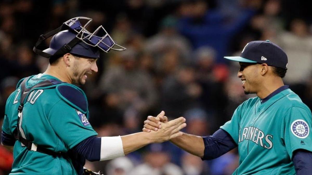 Seattle Mariners catcher Mike Zunino, left, and closer Edwin Diaz share congratulations after a recent win over the Rangers. Diaz is expected to be used for more than just closing to make sure he gets his share of innings.